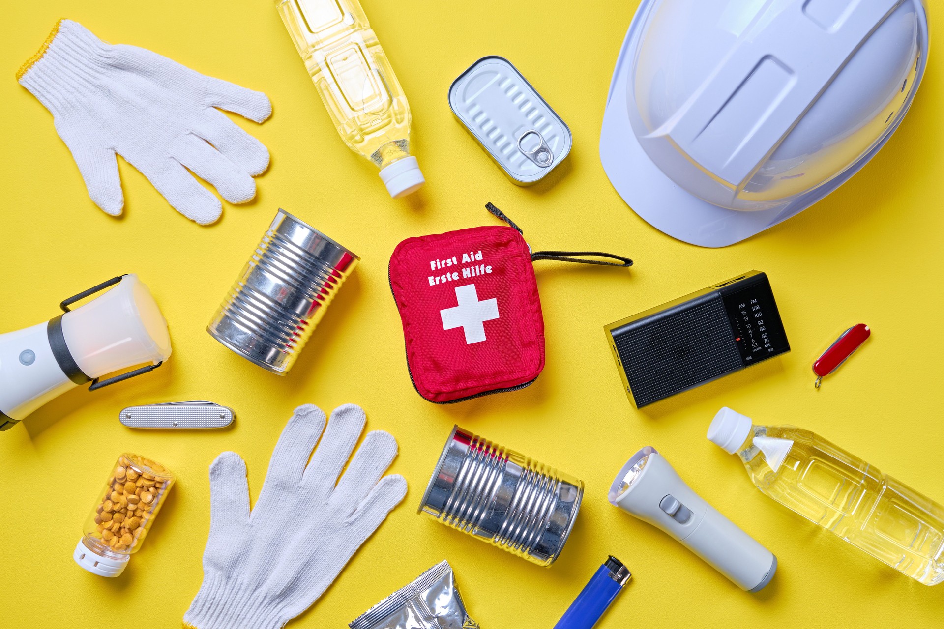 Disaster preparedness kit on yellow background.